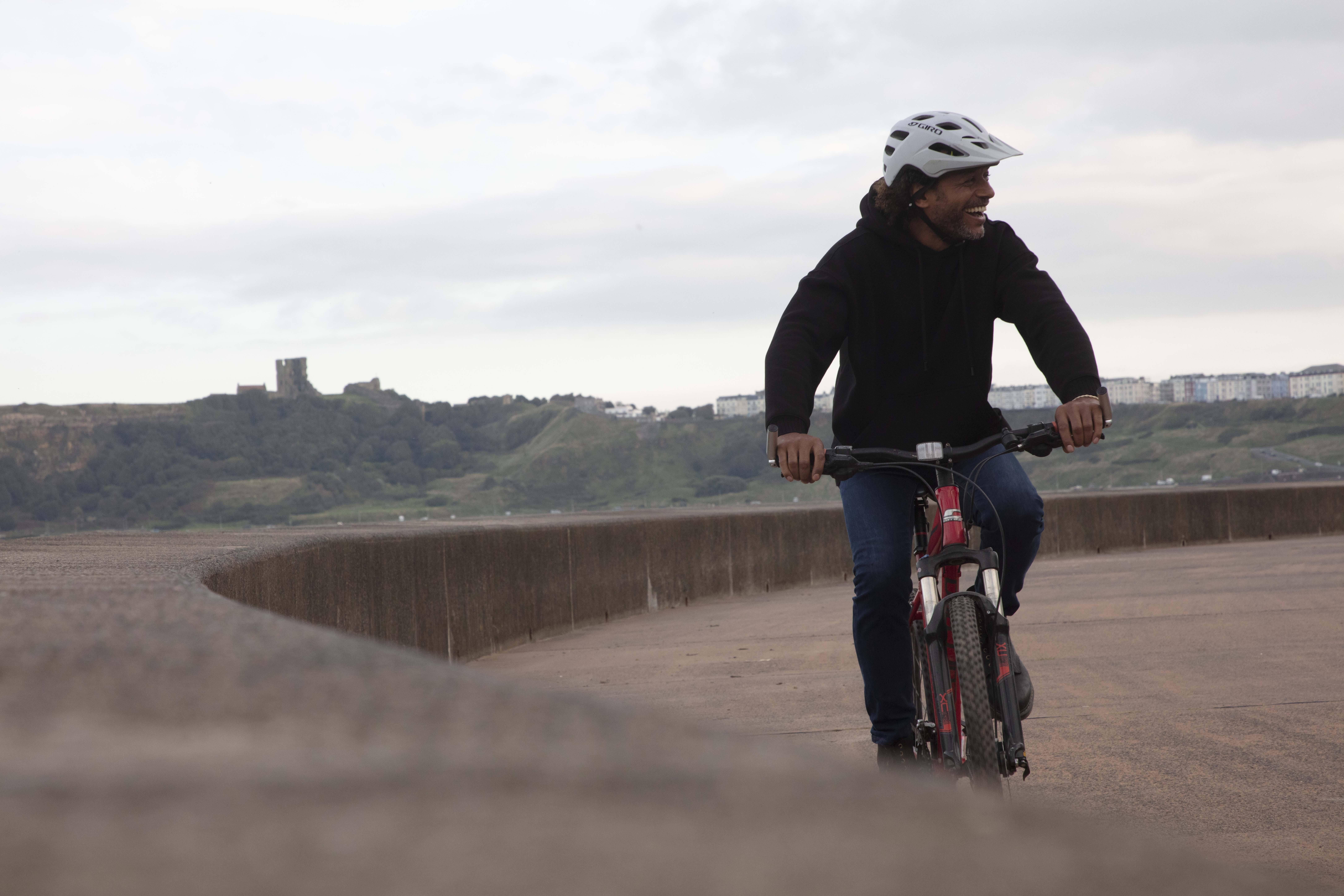 Man cycling with Castle in the background